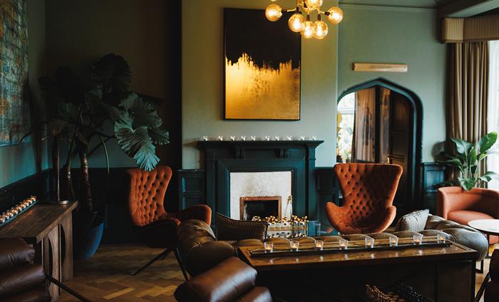 Seating area in front of a fireplace in a hotel lounge.